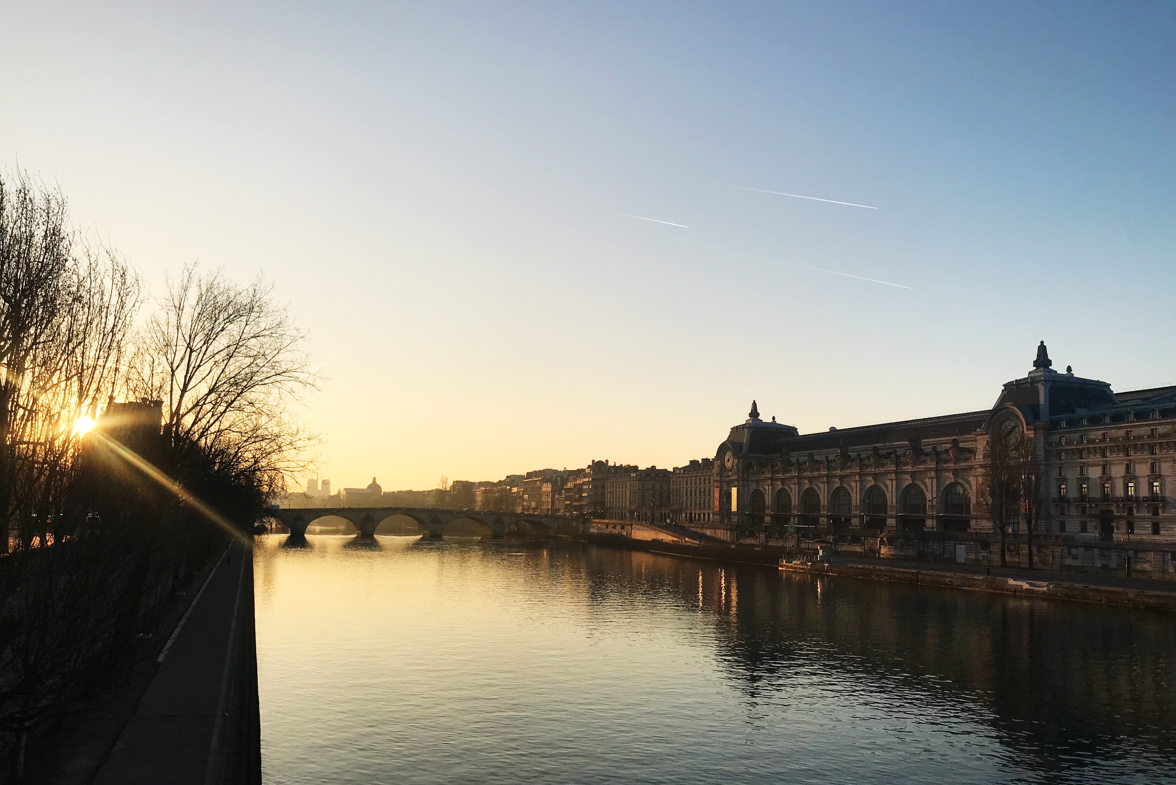 A photo of a sunrise over the Seine river in Paris, France